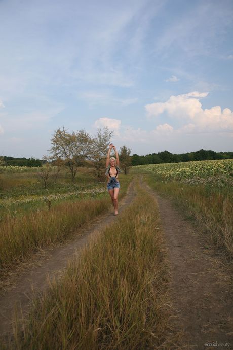 Young blonde Rina D bares herself on a blanket in the backyard