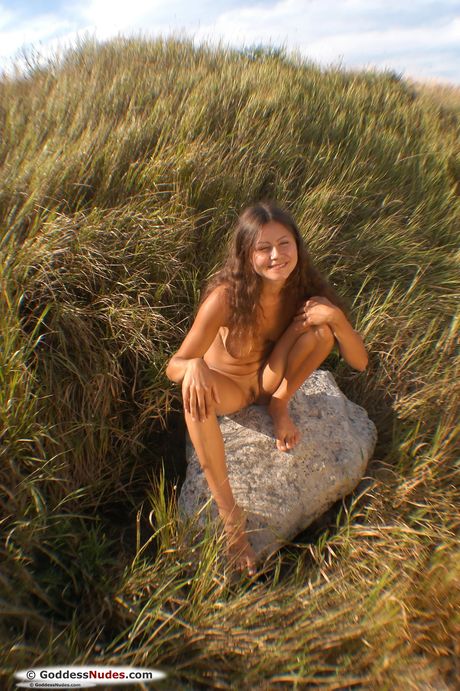 Petite teen Alena shows her small tits and exhibits perfect shape in a solo