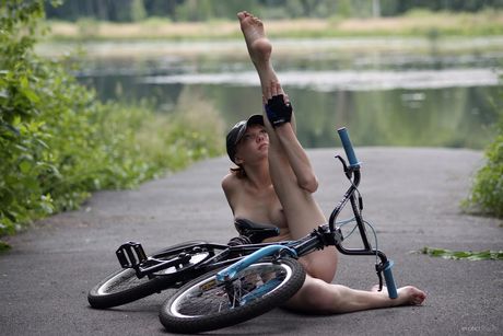 Young redhead Viv takes off everything on a backyard patio fearlessly