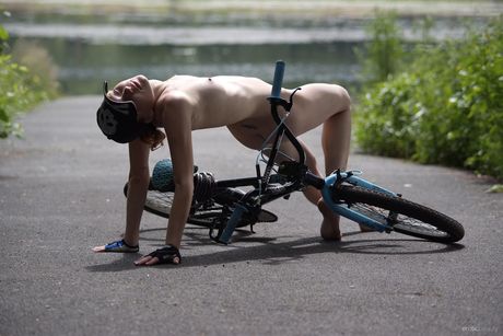 Young redhead Viv takes off everything on a backyard patio fearlessly