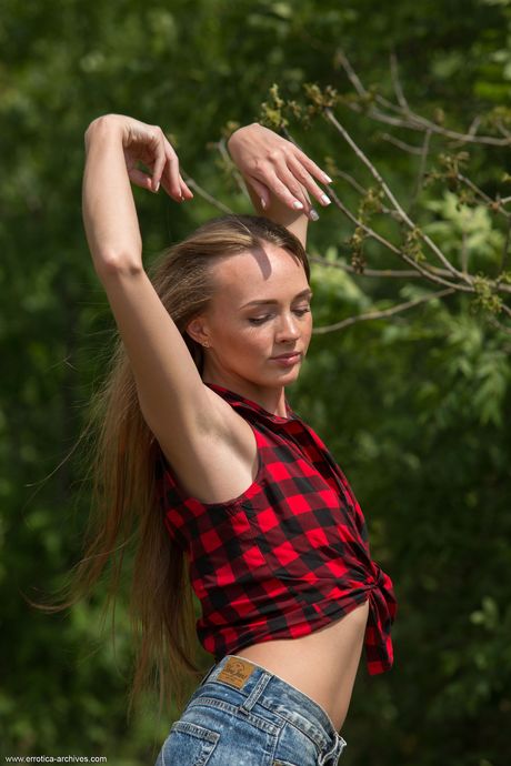 Thin teen Andrea Sixth gets nude on a fallen tree in the wild