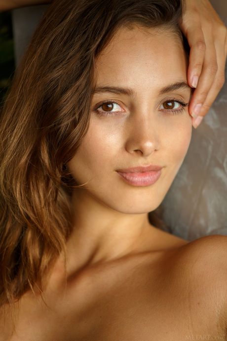 Magnetic teen Calypso removes a candy striped dress to get naked without shyness