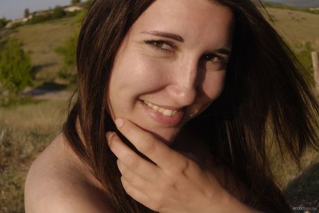 Slender teen Jasha models totally naked on a rocky outcropping