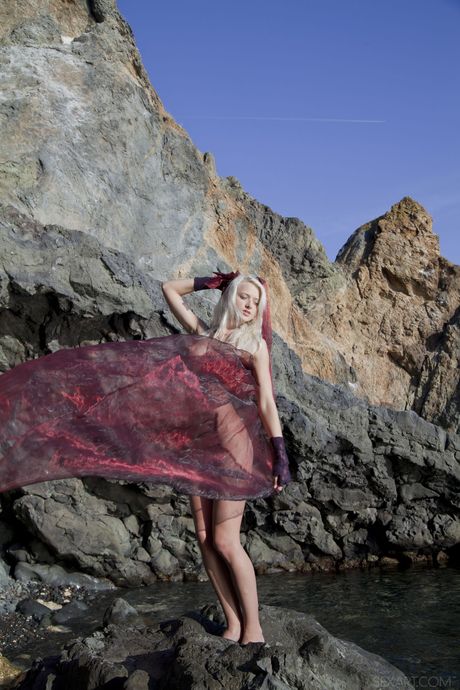 Blonde teen Nika N removes her bikini before fingering her pussy on a patio