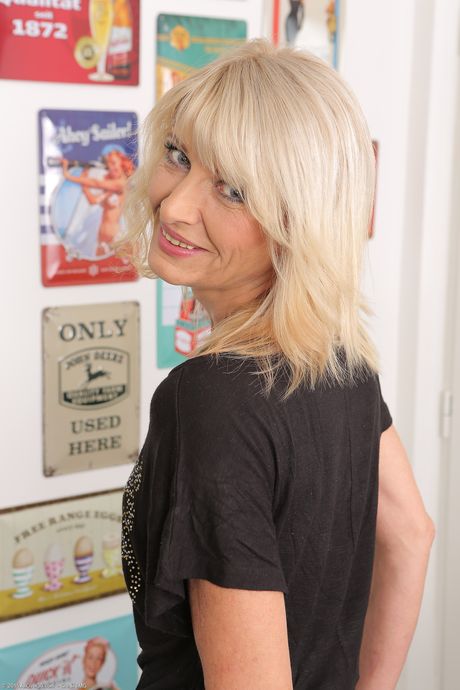 Blonde mature Laura Fabroni shows her tiny tits and spreads her pussy