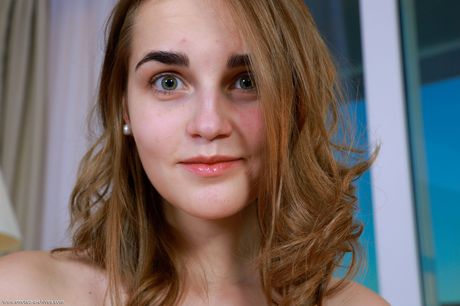 Olga Zz demonstrates her beautiful body and sweet pussy as she poses on the couch