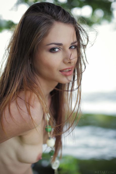 Naked teen Loretta A models on a dock and in a small boat