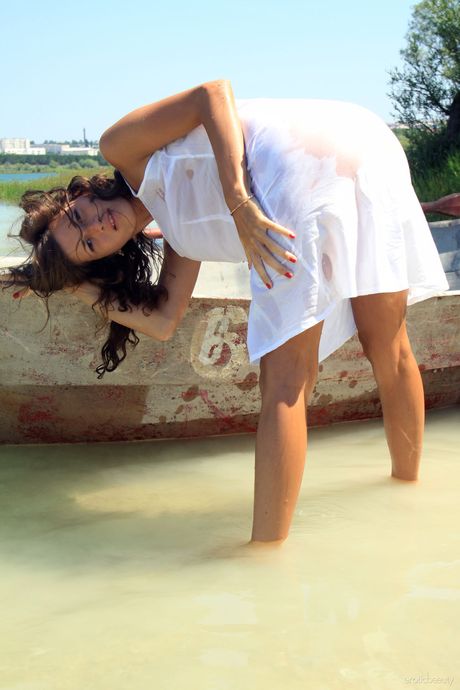 Sexy Russian beautiful Salomja A gets naked on a dory before going for a swim