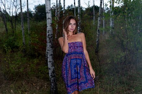 Svelte teen Gracie removes a black dress to pose nude in the forest