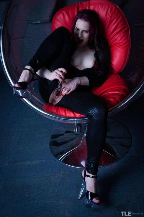 Gorgeous teen Candi removes a black jumpsuit before toying her pussy