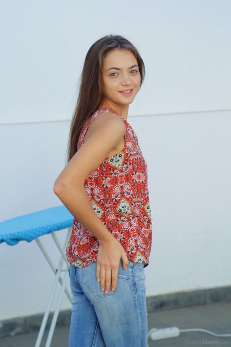 Lovely teen Angely Grace shows her tiny tits and poses naked in a solo