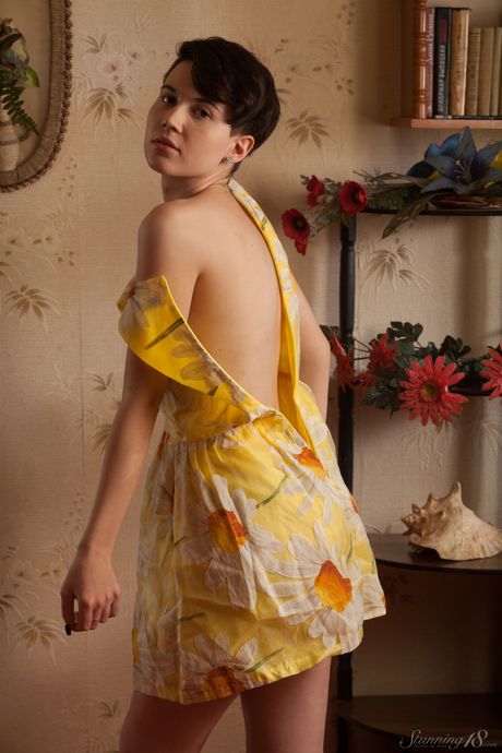 Brunette teen Kerri models in the nude on a bed without hesitation