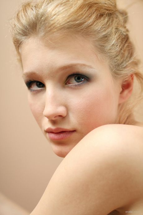 Skinny teen Mila F poses nude in a pair of high heels on a wooden floor