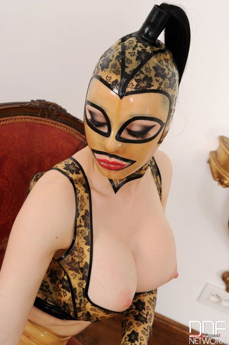 British cougar Latex Lucy displays her big tits & her ass in a fetish solo