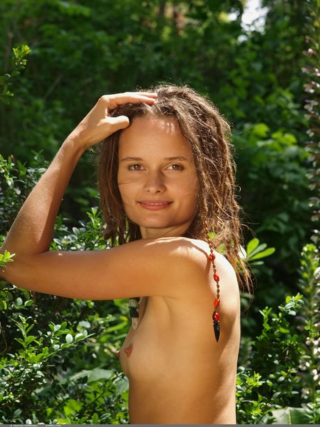 Slender teen Kova poses totally naked on a rocky outcropping