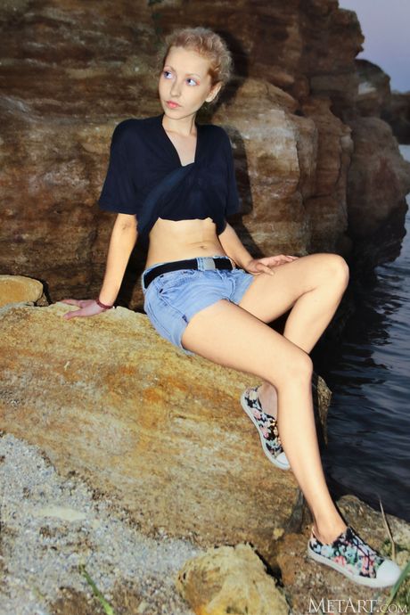 Pretty teen Tooya gets naked on a beach before getting in the water