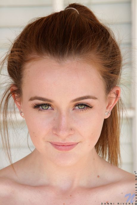 Young redhead Danni Rivers masturbates on a yoga ball with a dildo in socks