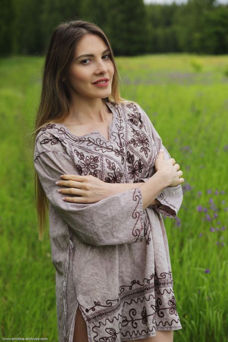 Blonde teen Kira bares her body in a field of wildflowers during solo action