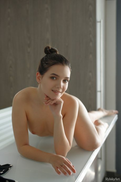 Lean teen Chanel Fenn shows her tiny tits and poses naked in the kitchen