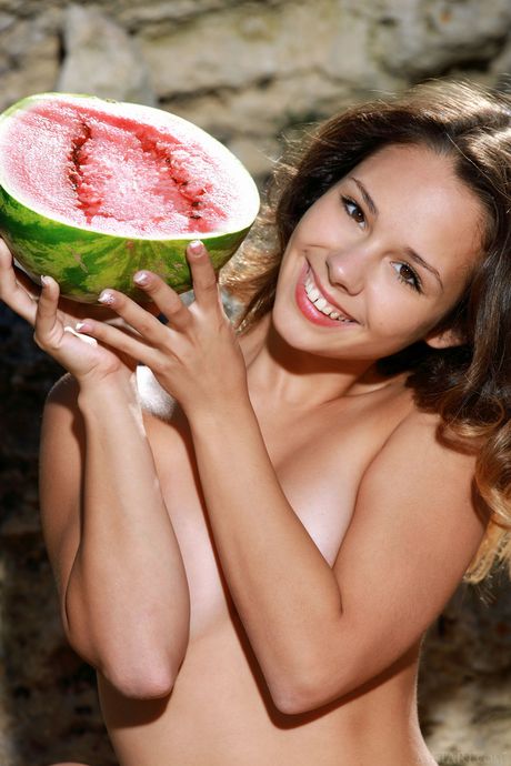 Russian beauty Emmy poses nude among watermelons in the backyard