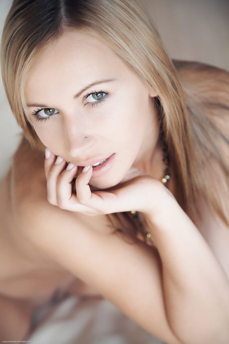 Lovely teen girl with a landing strip pussy poses nude in high heels