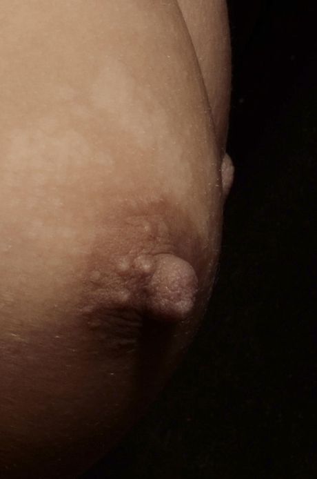 Sexy blonde Jeanie strips to her stockings & spreads her pussy on the sofa