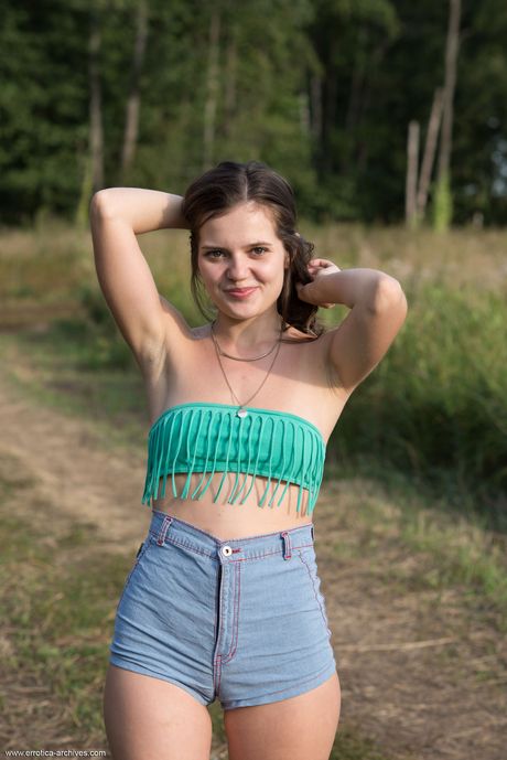 Sweet Ukrainian beauty Pola strips naked in the grass outdoors