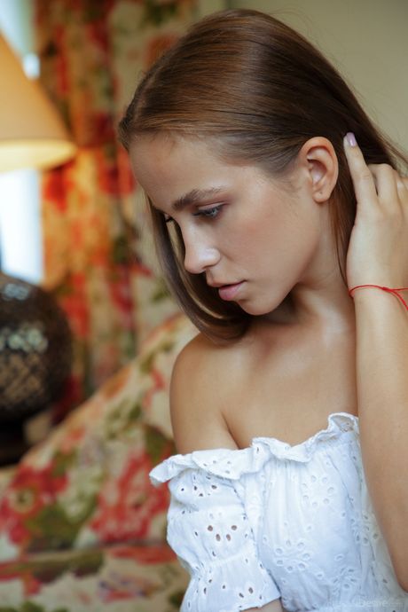 Delightful teen Cassia takes it all off on a leather chair during solo action