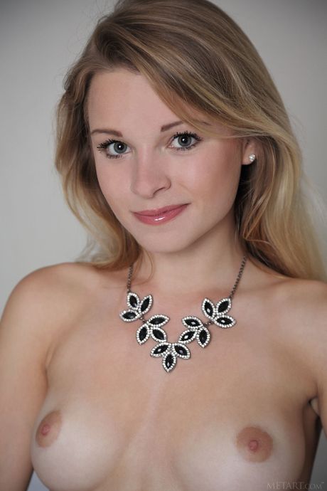 Cute teen Malinda A removes her stockings to get totally naked