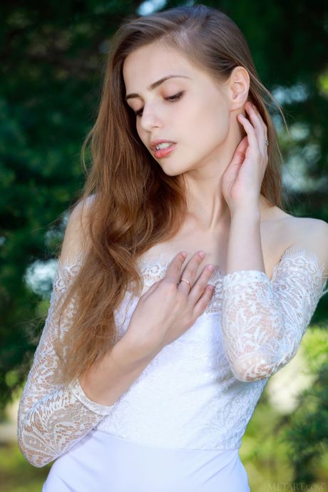 Skinny teen Elle Tan bares her body in a forest