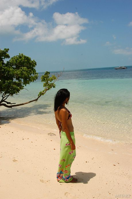 Sexy Asian teen Mey removes her lingerie to pose nude on a beach