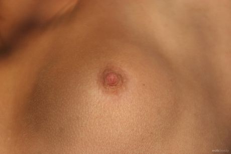 Blonde teen Sandy A bares all in a field of tall grasses