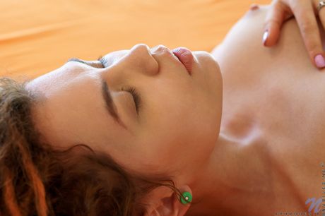 Redheaded teen Aphrodesia removes her panties before fingering her pussy