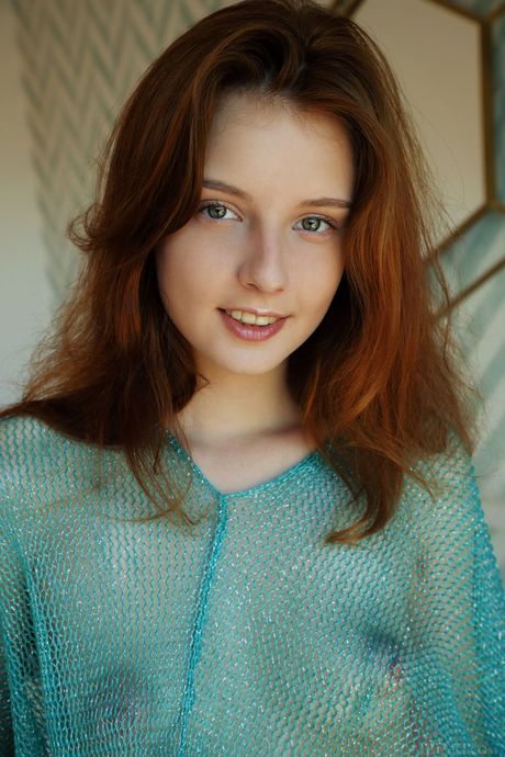 Alluring teen Sienna removes a see thru top to get naked boldly