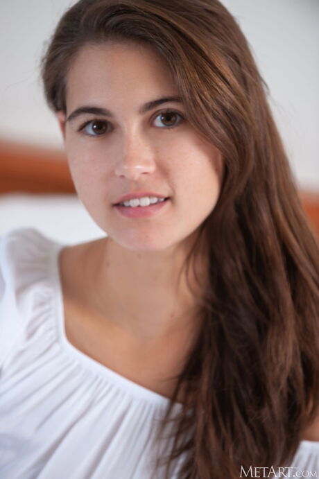 Nina Sphinx gets naked on her bed and exhibits her sexy body