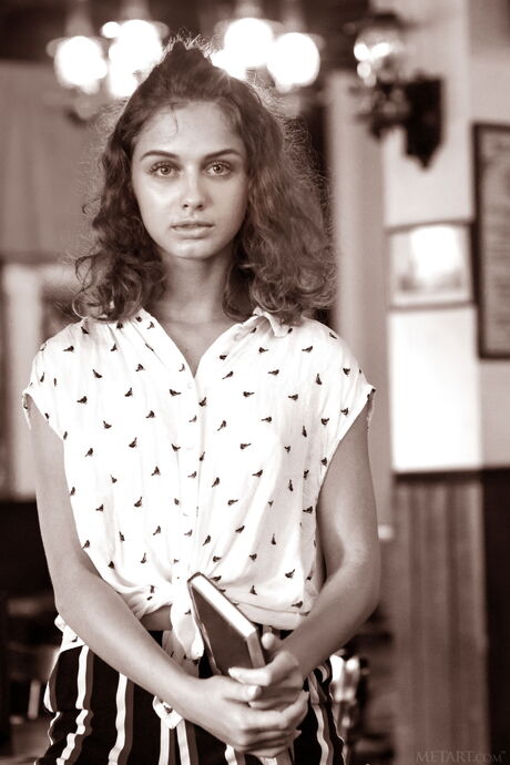 Brunette teen Clarice strips off on a patio with certainty