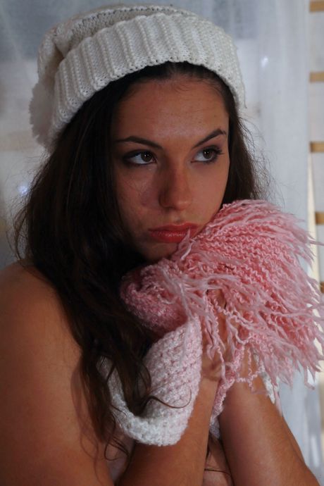 Cute teen Alisha gets naked in a red hat and socks on a Christmas tree