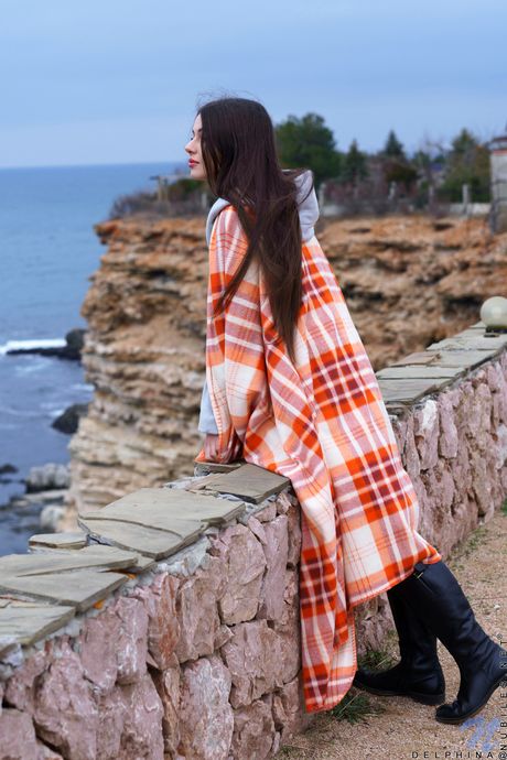 Young brunette Delphina goes naked in a pair of boots in a bedroom