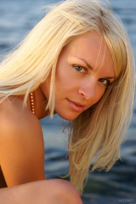 Blonde teen Helen F gets naked on a rocky beach without shyness