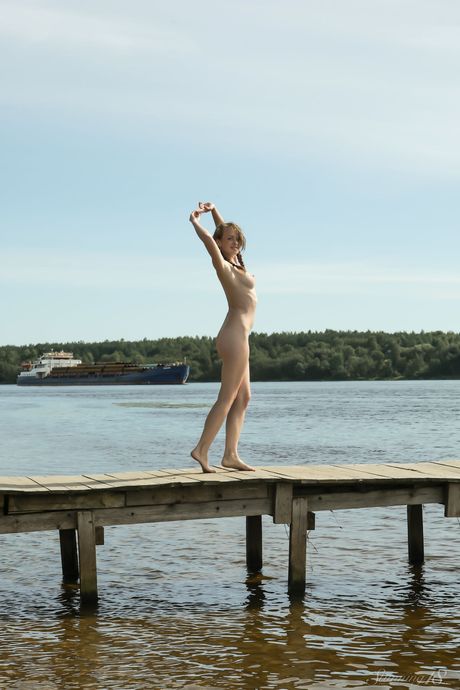 Young blonde Vega models totally naked on a dock in a lake