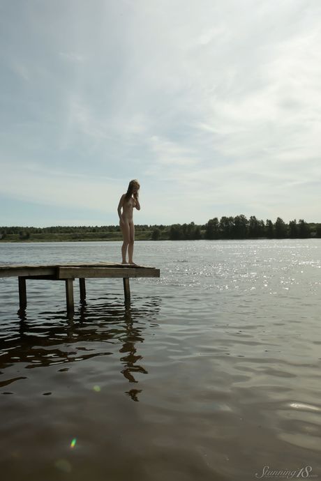 Young blonde Vega models totally naked on a dock in a lake