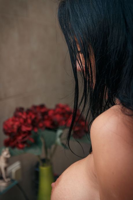 Brunette teen Rebeka removes a black bodystocking before masturbating in a shower