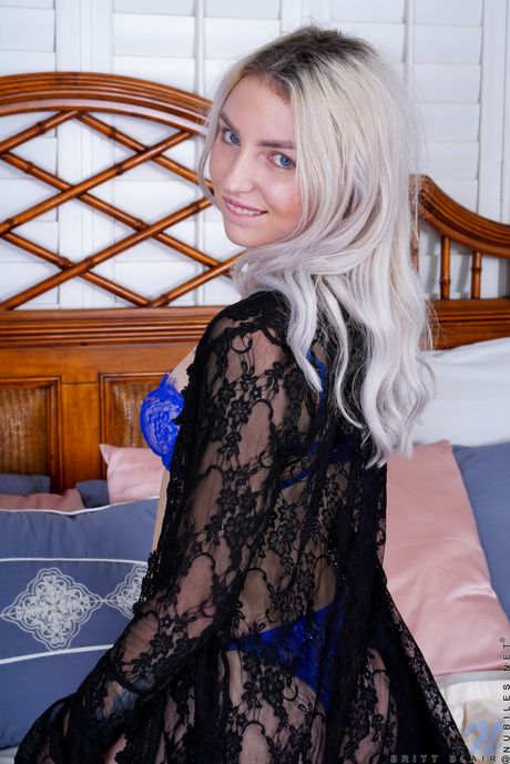 Skinny blonde Britt Blair strips off her lingerie to pose nude in her bedroom