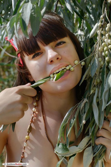 Black MO poses naked under the trees to show off her big tits and ass