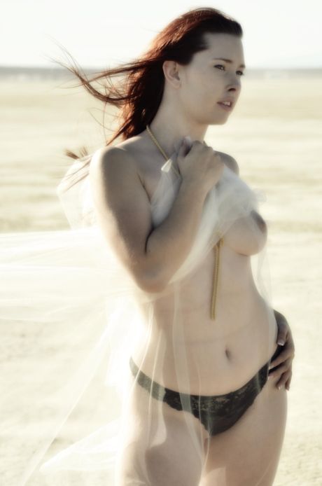 Natural redhead Melody Jordan gets naked on a balcony in high heels