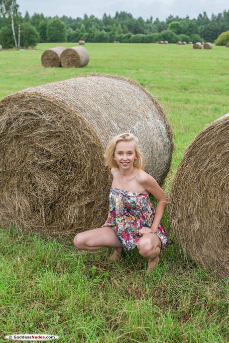 Barely legal girl Bernie models in the nude on a bed confidently