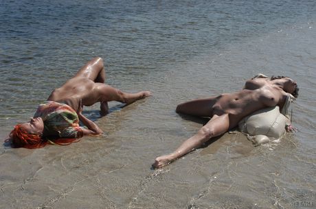 Beautiful teen babes Rebecca B & Yana D pose nude on the beach and in the water