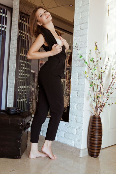 Delicate teen Emma Sweet removes her black suit and panties to pose nude