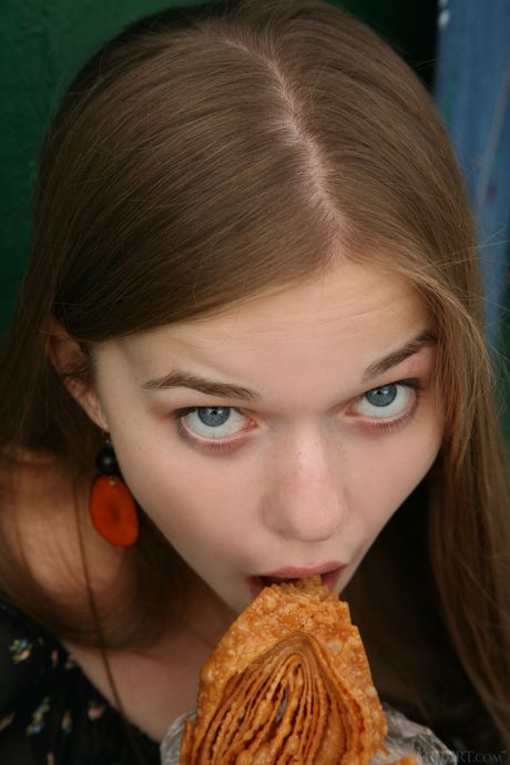 Blonde teen Milena D shows her landing strip pussy while naked on a bed