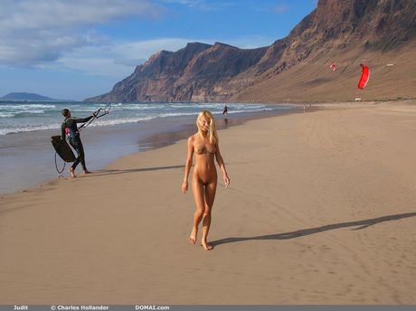 Cute teen Judit showing off her tiny tits & her shaved cunt on the beach